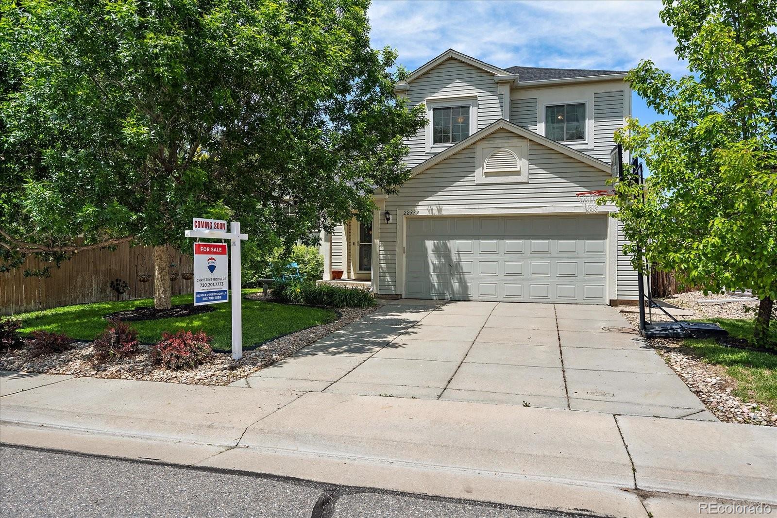 22379 East Dorado Avenue Aurora, CO 80015 - Photo 1 of 30 a front view of a house with a yard and a garage