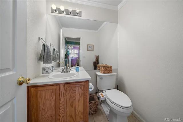 a bathroom with a granite countertop toilet sink and mirror