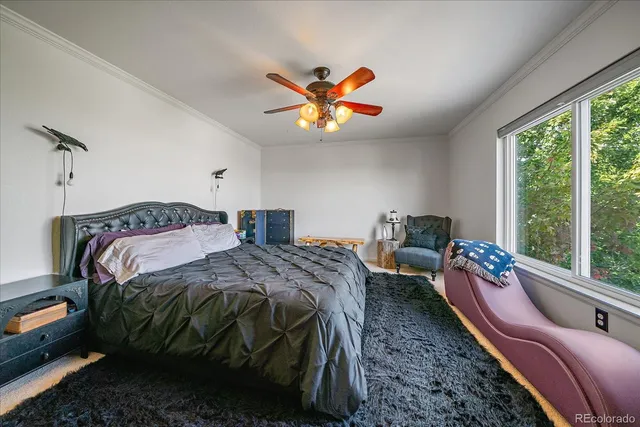 a bedroom with bed and a large window