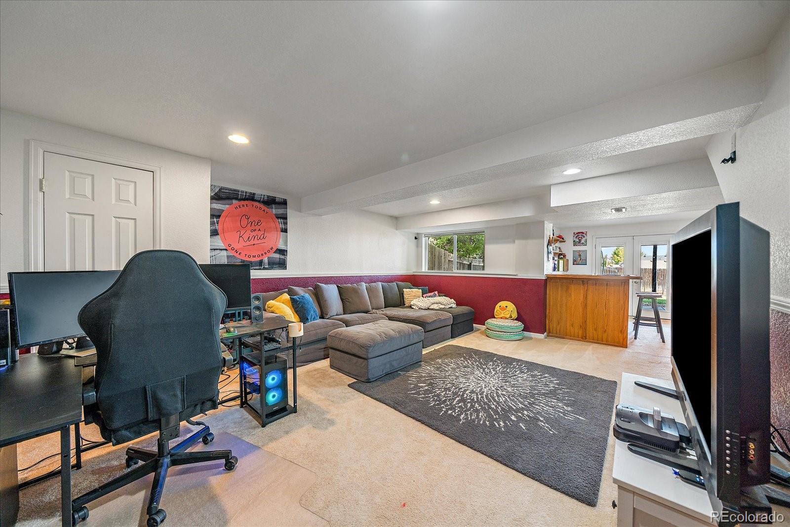 22379 East Dorado Avenue Aurora, CO 80015 - Photo 23 of 30 a living room with furniture and a flat screen tv
