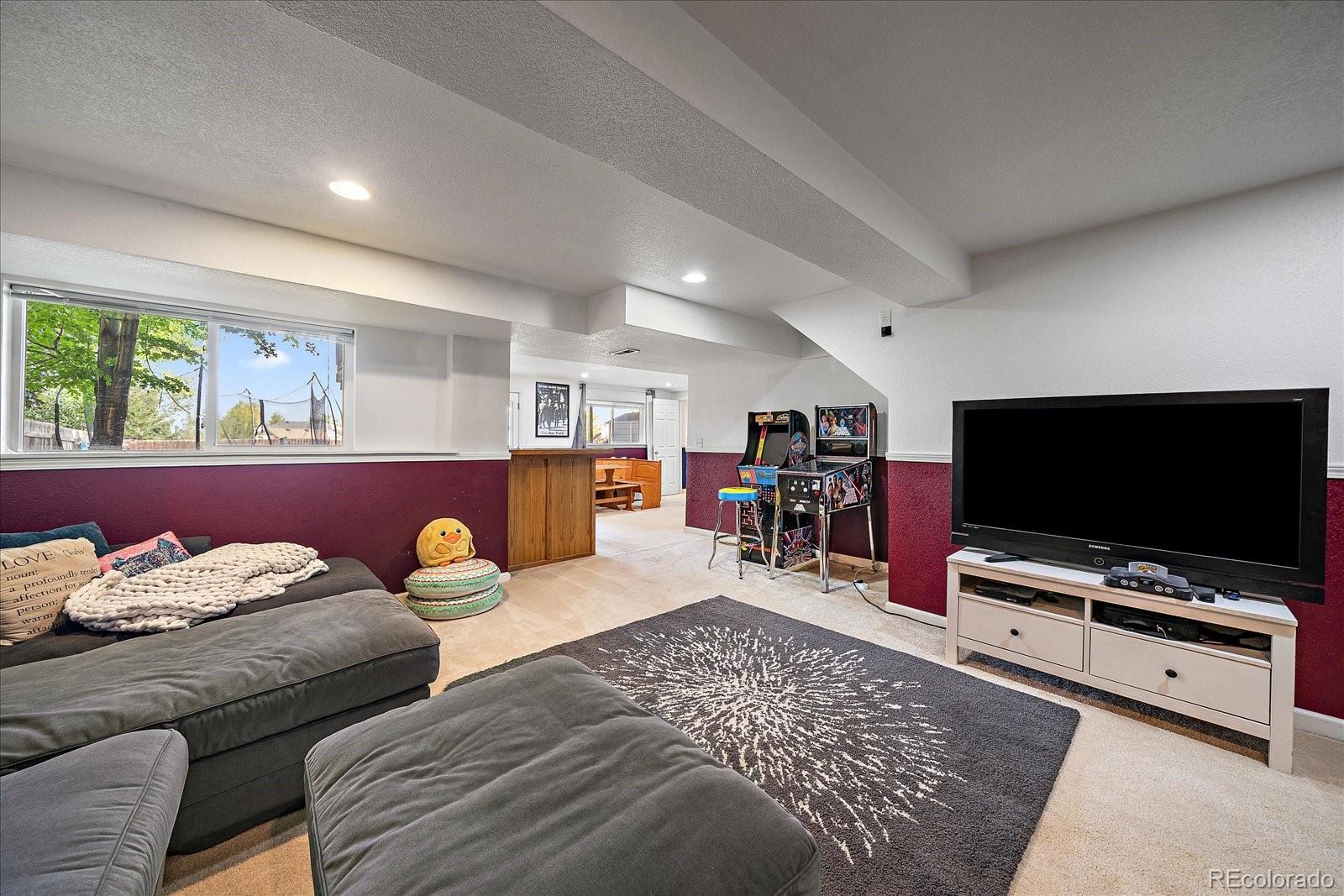 22379 East Dorado Avenue Aurora, CO 80015 - Photo 25 of 30 a living room with furniture and a flat screen tv