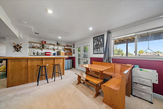 a living room with furniture a flat screen tv and a large window