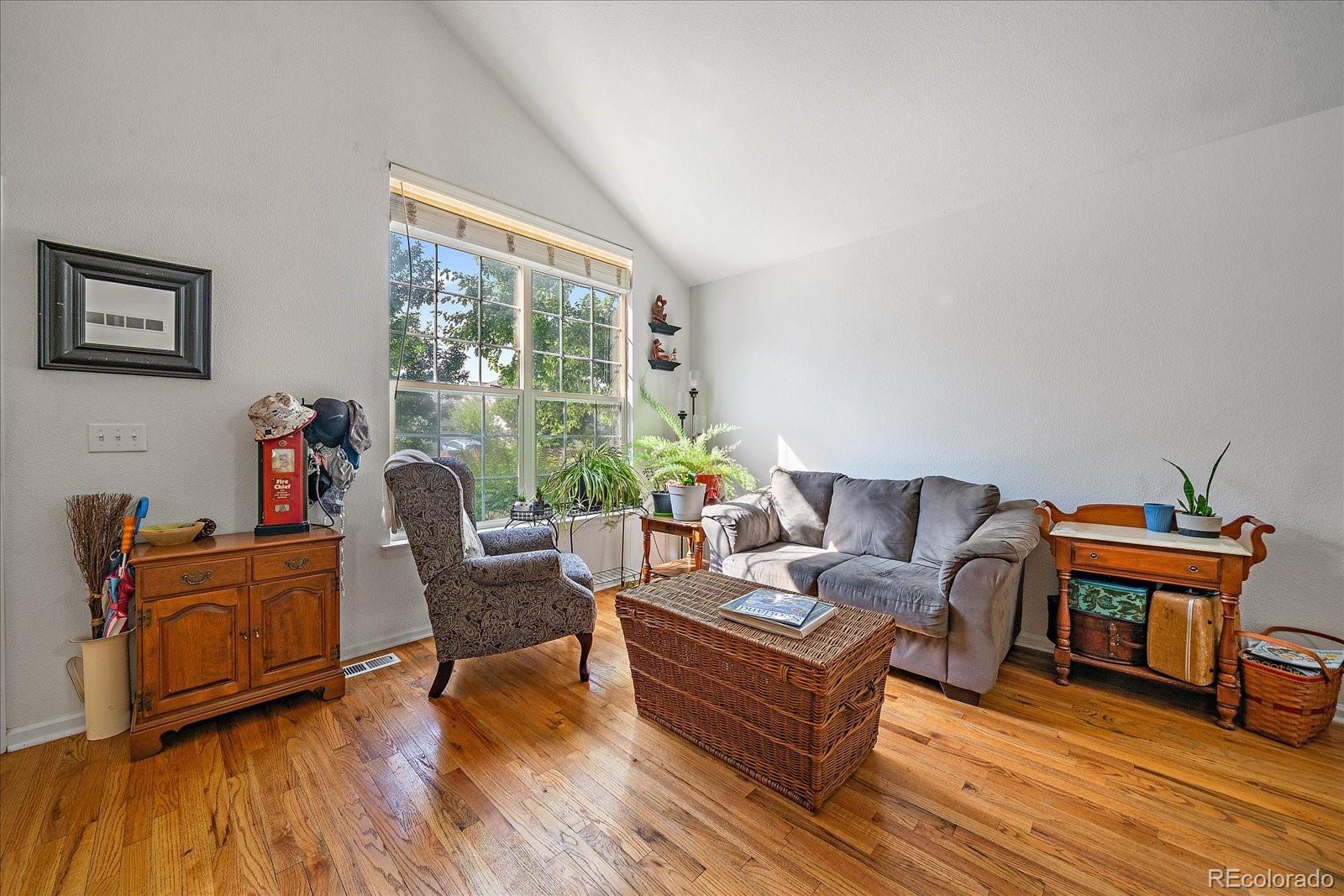 22379 East Dorado Avenue Aurora, CO 80015 - Photo 5 of 30 a living room with furniture and a wooden floor