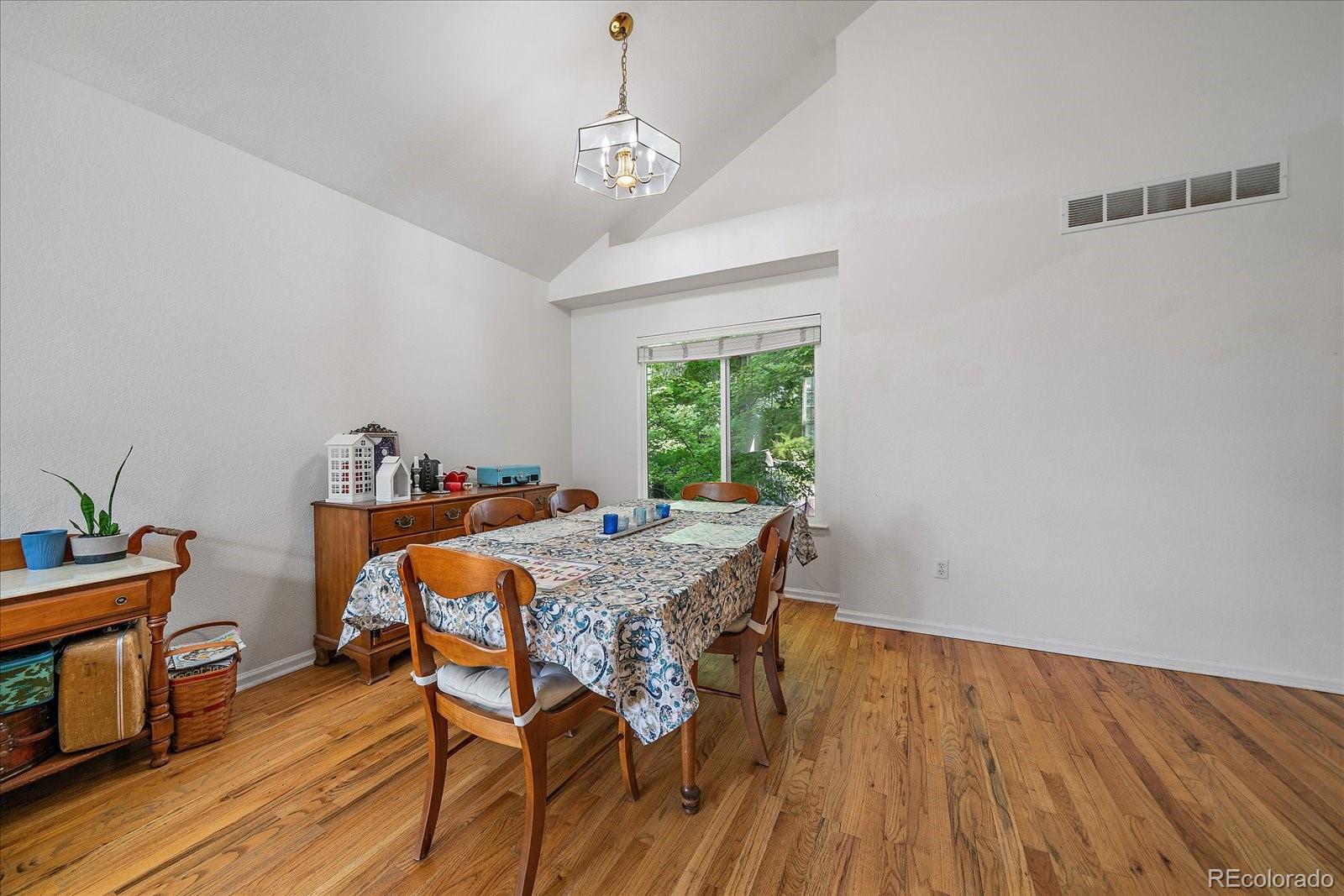 22379 East Dorado Avenue Aurora, CO 80015 - Photo 6 of 30 a view of a dining room with furniture window and wooden floor
