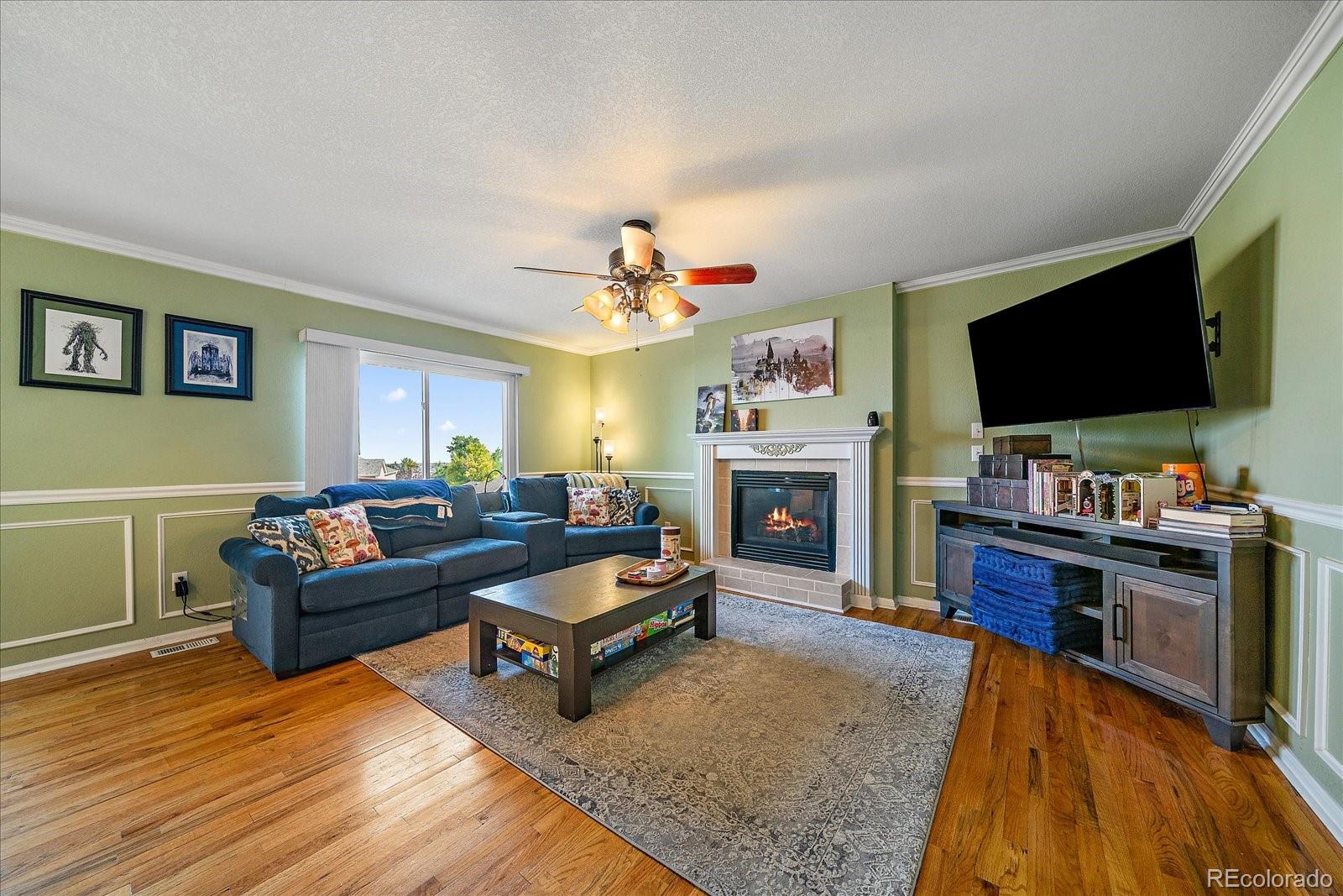 22379 East Dorado Avenue Aurora, CO 80015 - Photo 8 of 30 a living room with furniture and a flat screen tv