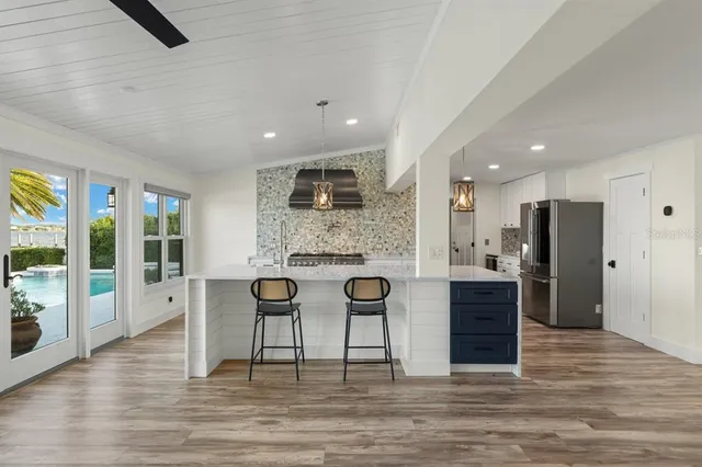 a kitchen with stainless steel appliances a sink dishwasher stove and refrigerator