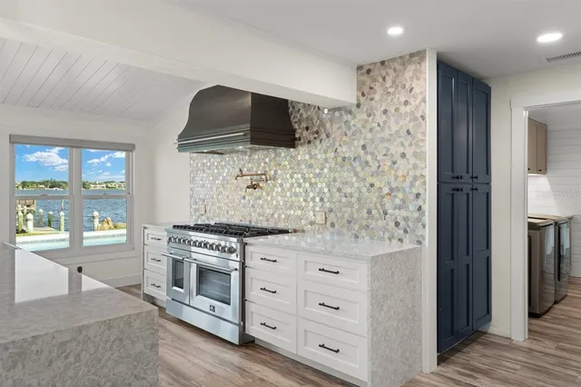 a kitchen with stainless steel appliances a stove a sink and a refrigerator