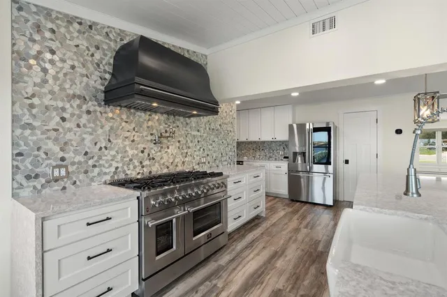 a kitchen with stainless steel appliances a refrigerator and a sink