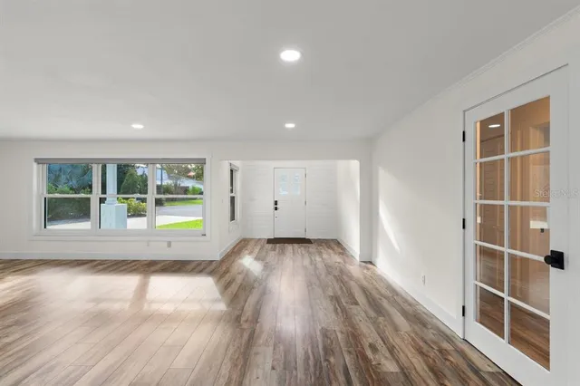 a view of a room with wooden floor and window