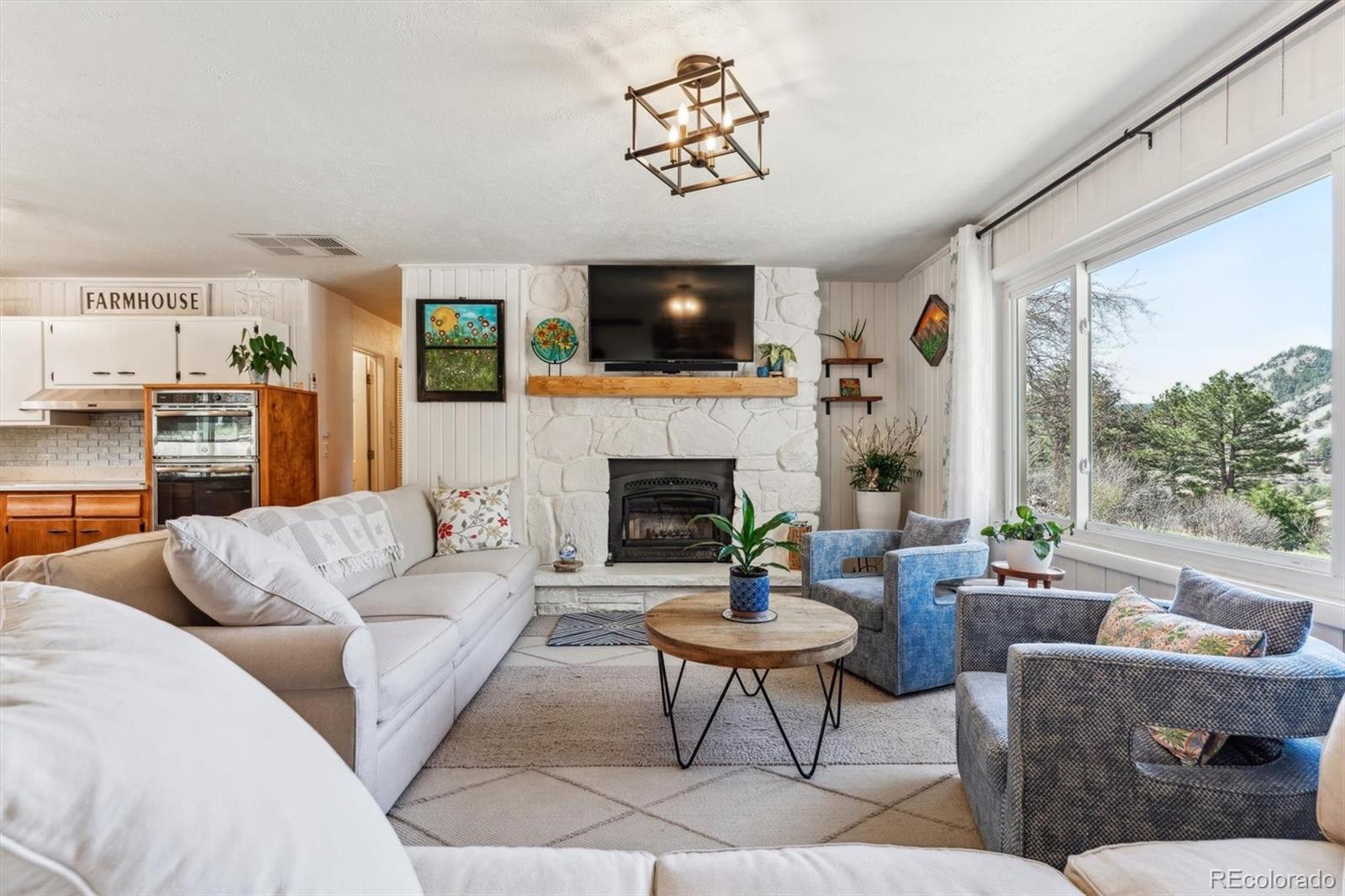 5384 Olde Stage Road Boulder, CO 80302 - Photo 20 of 49 a living room with furniture fireplace and flat screen tv