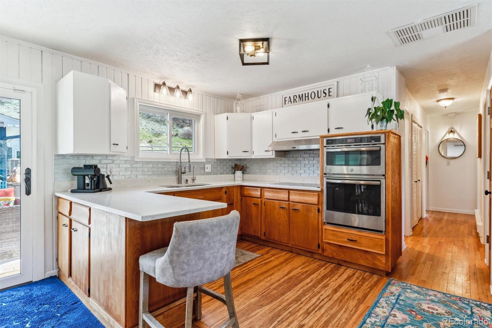 5384 Olde Stage Road Boulder, CO 80302 - Photo 23 of 49 a kitchen with stainless steel appliances granite countertop a stove a sink dishwasher and a refrigerator with wooden floor