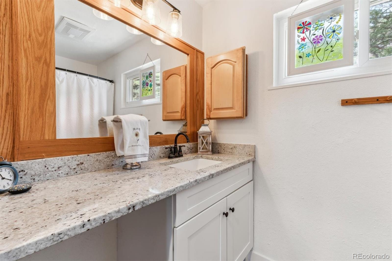 5384 Olde Stage Road Boulder, CO 80302 - Photo 35 of 49 a bathroom with a granite countertop sink and a window