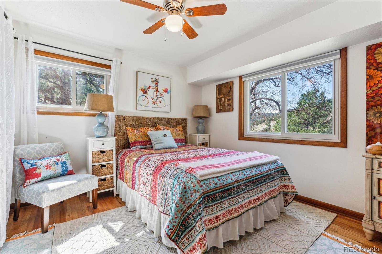 5384 Olde Stage Road Boulder, CO 80302 - Photo 36 of 49 a bedroom with a bed and wooden floor