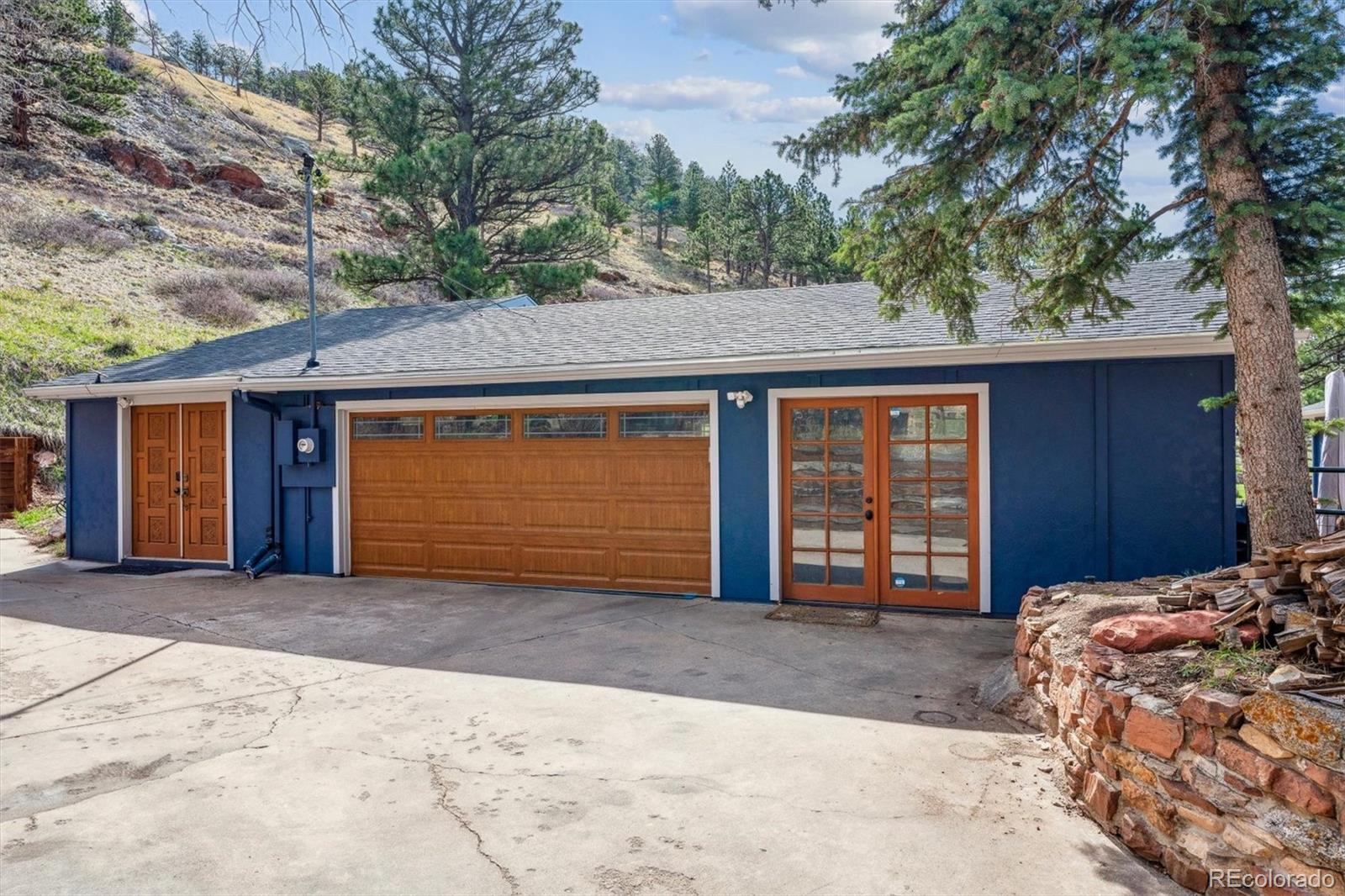 5384 Olde Stage Road Boulder, CO 80302 - Photo 7 of 49 a front view of a house with a yard and garage