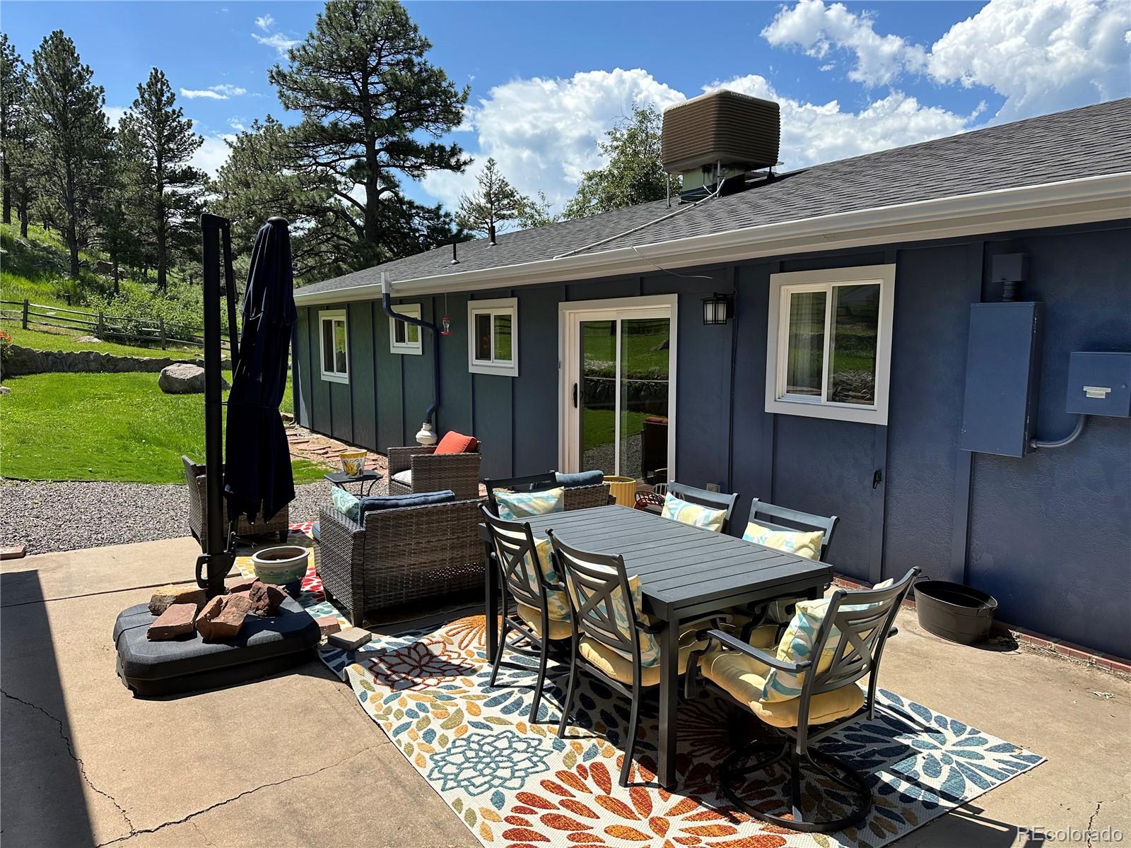 5384 Olde Stage Road Boulder, CO 80302 - Photo 10 of 49 a view of a patio with table and chairs potted plants and a large tree