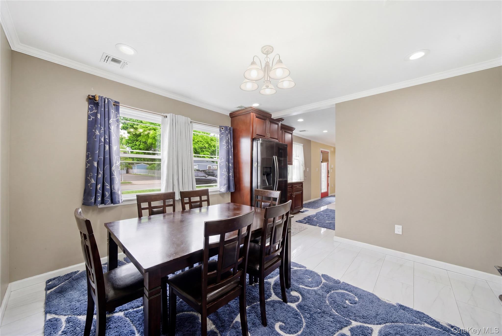 50 Ridge Lane Levittown, NY 11756 - Photo 12 of 27 a dining room with furniture a chandelier and window