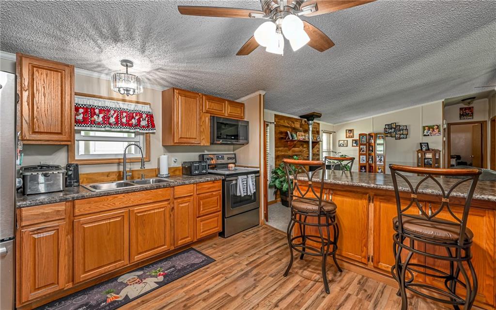 307 Hungarian Road Slippery Rock, PA 16057 - Photo 11 of 34 a kitchen with stainless steel appliances granite countertop a dining table chairs sink and cabinets