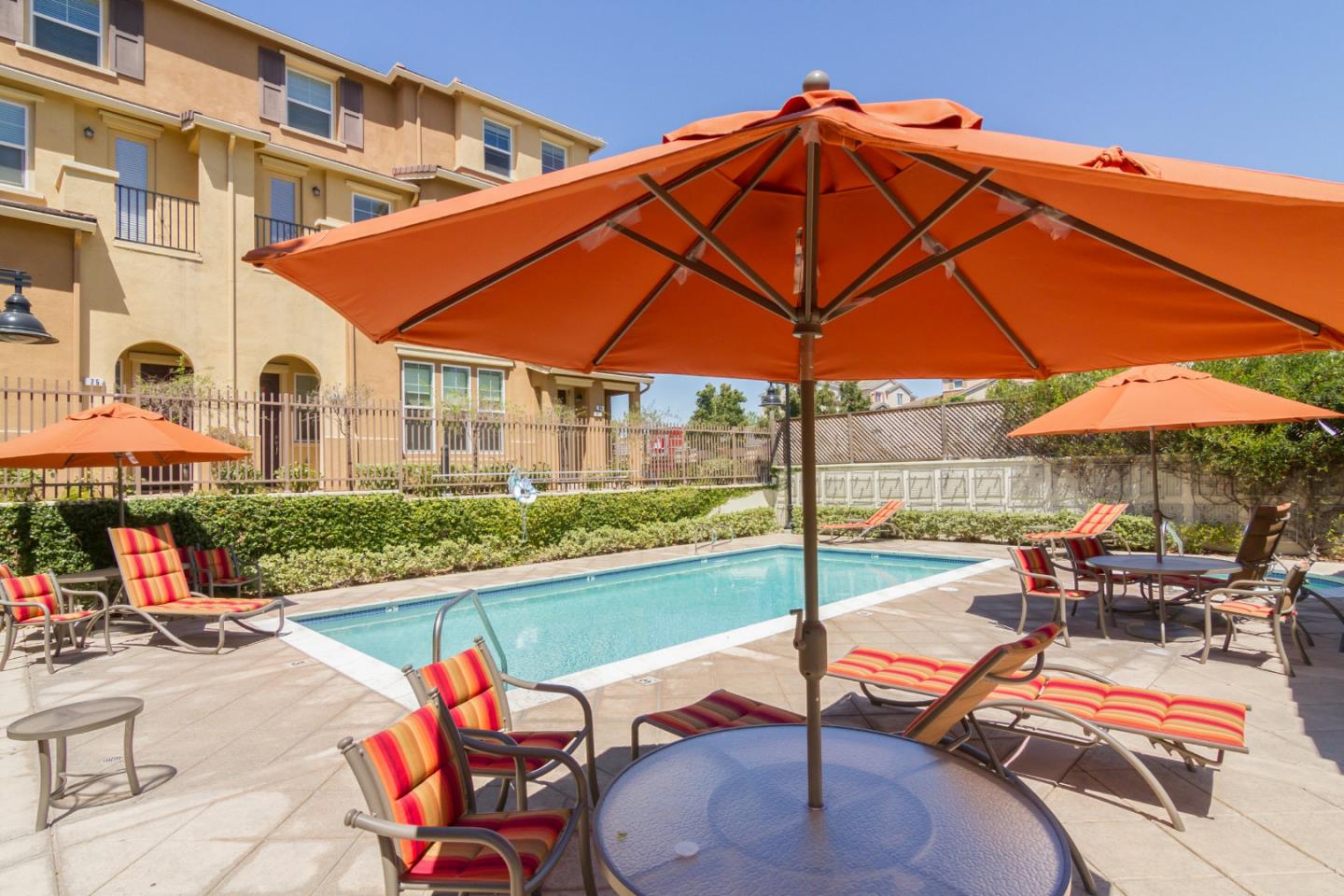 1756 Snell Place Milpitas, CA 95035 - Photo 21 of 22 a patio with a table and chairs under an umbrella