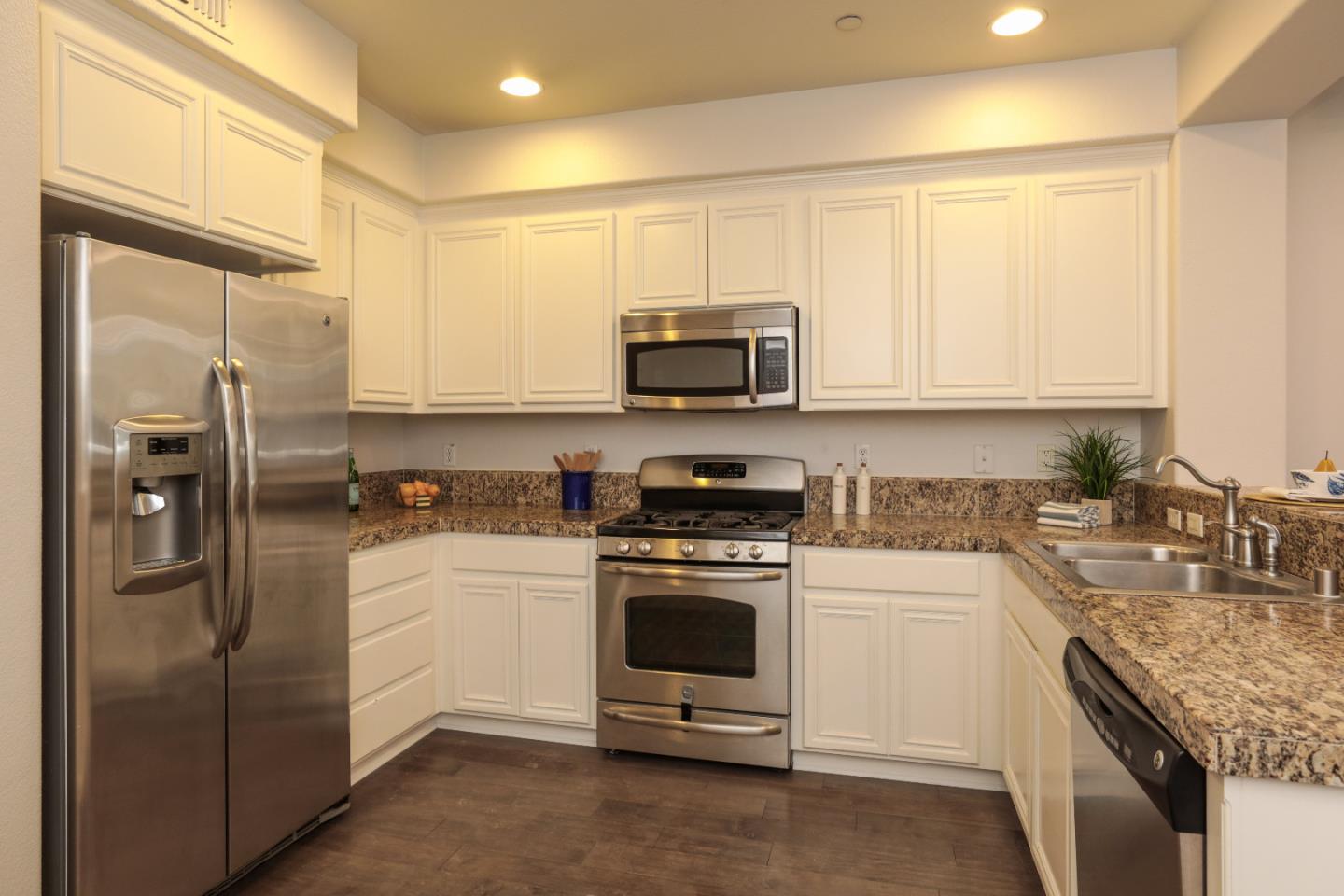 1756 Snell Place Milpitas, CA 95035 - Photo 5 of 22 a kitchen with stainless steel appliances granite countertop a stove a refrigerator and a sink