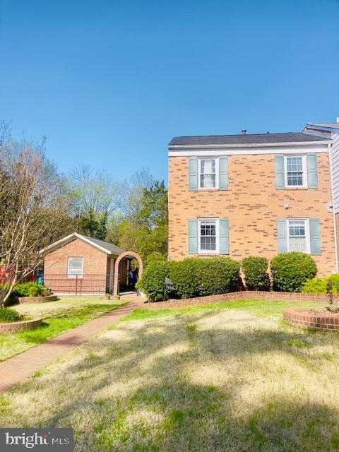 7458 Colton Lane Manassas, VA 20109 - Photo 4 of 5 a front view of a house with a yard and garage