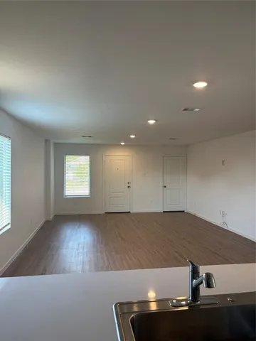 an empty room with wooden floor