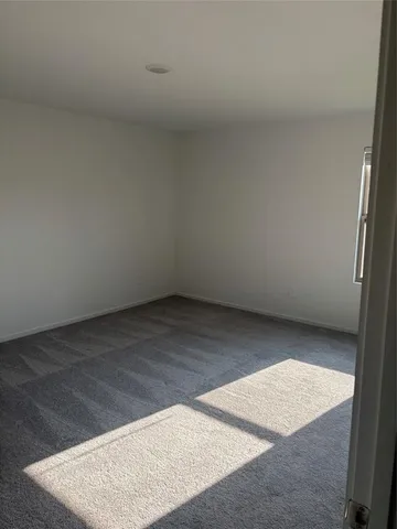 an empty room with wooden floor