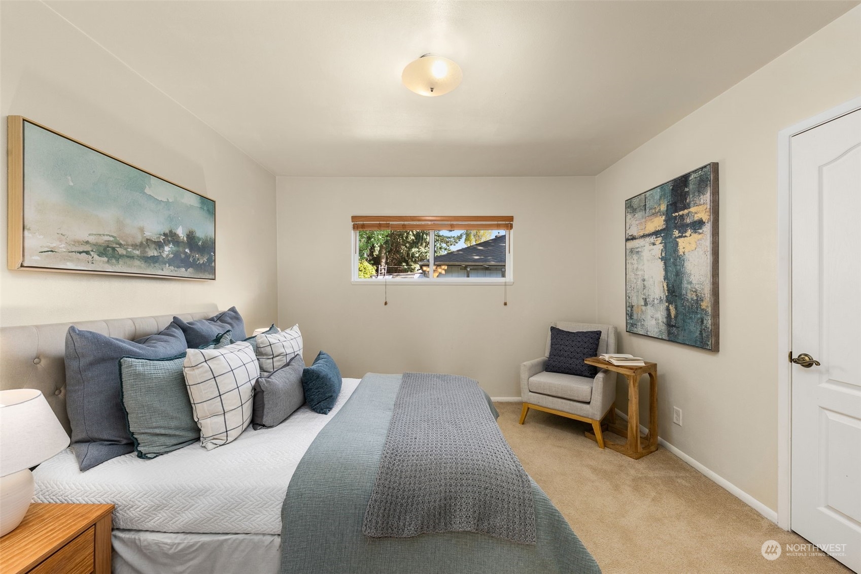 8123 28th Avenue Southwest Seattle, WA 98126 - Photo 11 of 31 a bedroom with a bed and a painting on the wall