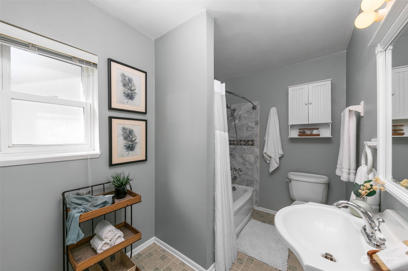 8123 28th Avenue Southwest Seattle, WA 98126 - Photo 18 of 31 a bathroom with a toilet a sink and a mirror