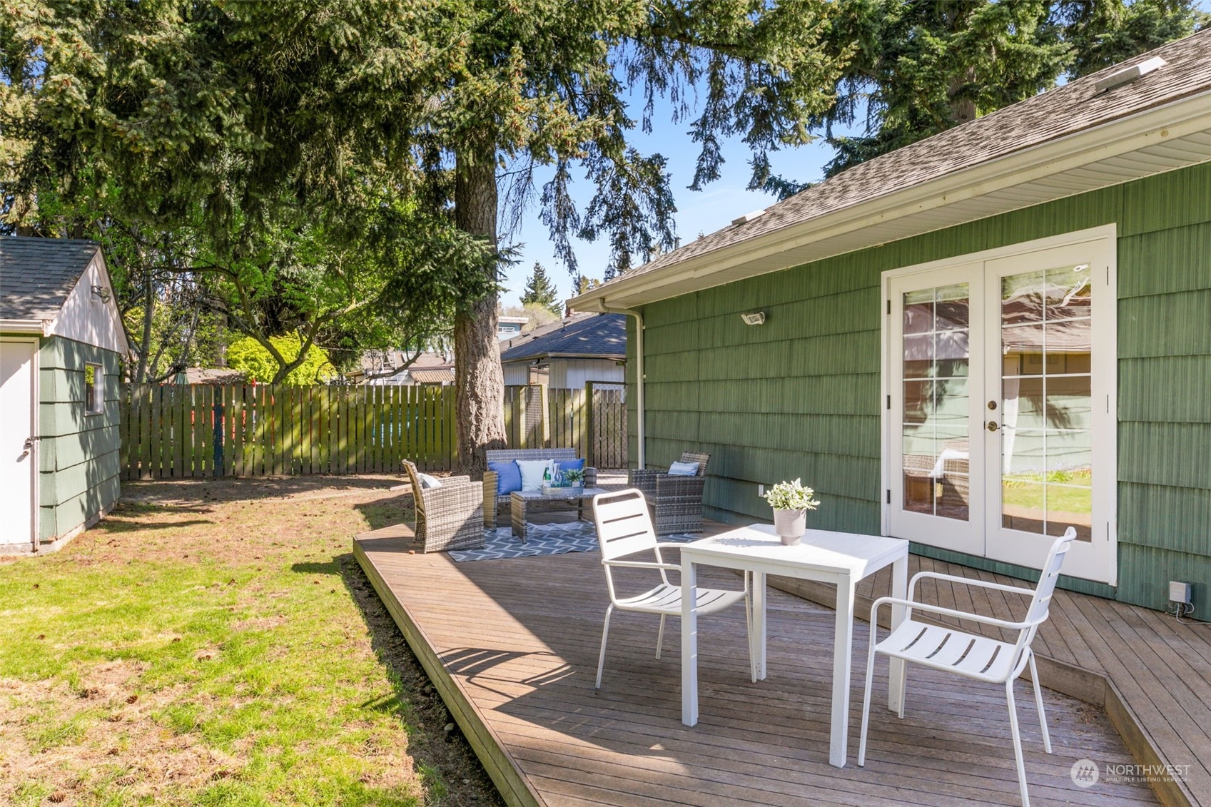 8123 28th Avenue Southwest Seattle, WA 98126 - Photo 22 of 31 a view of a patio with table and chairs and potted plants