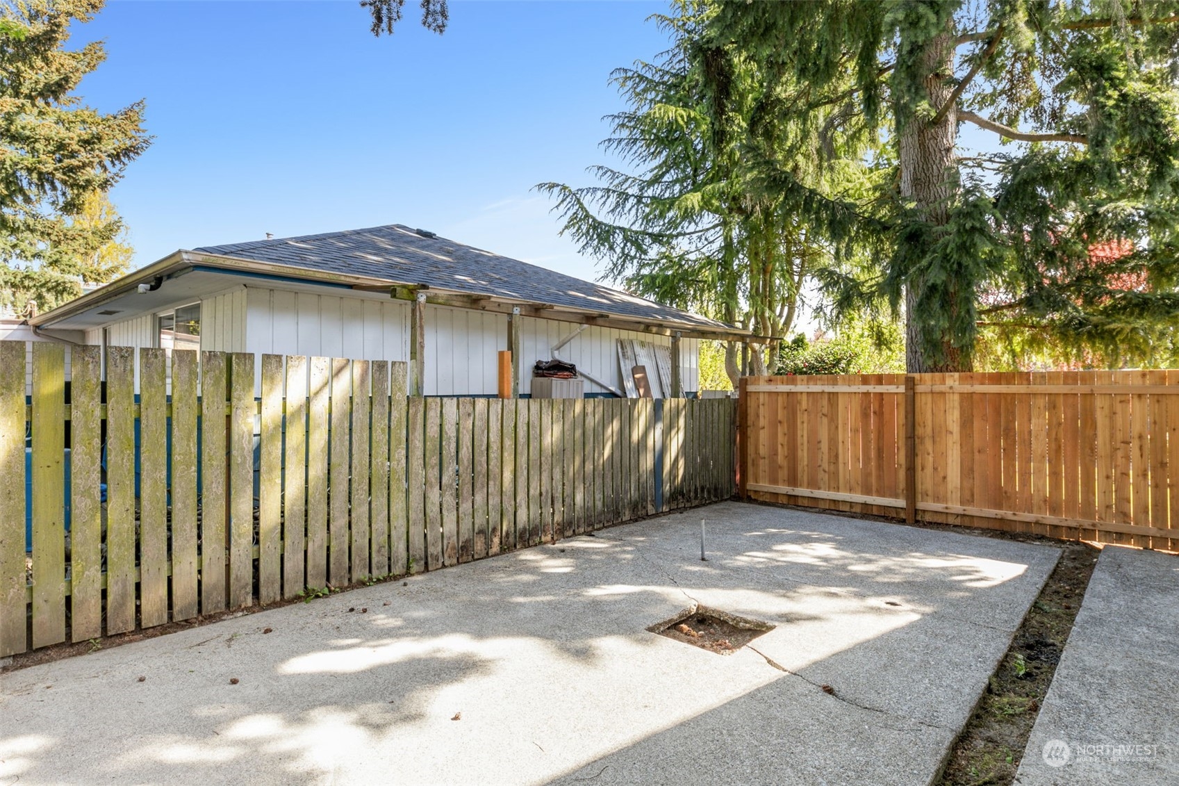 8123 28th Avenue Southwest Seattle, WA 98126 - Photo 24 of 31 a view of a small house with wooden fence