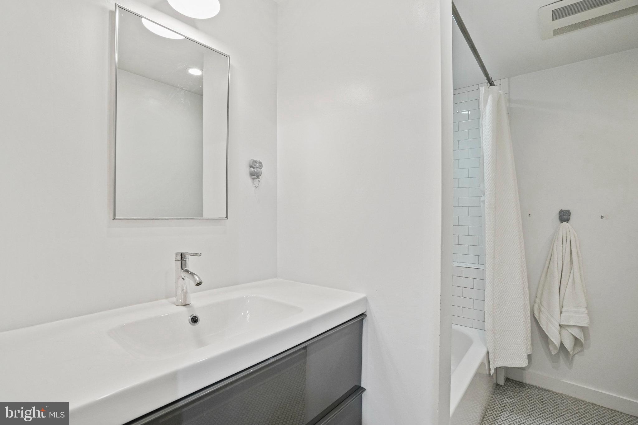1217 E Street Northeast Washington, DC 20002 - Photo 25 of 46 Sleek hall bath w/vanity has toilet niche