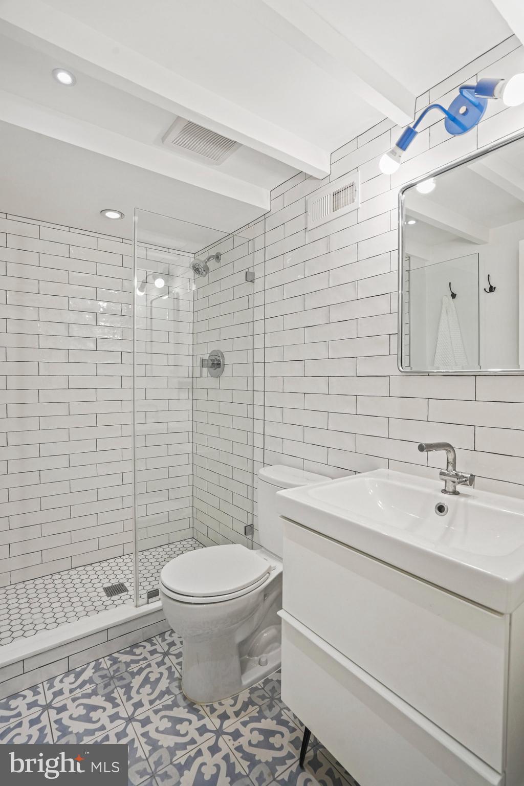 1217 E Street Northeast Washington, DC 20002 - Photo 34 of 46 Glass shower, subway tiled walls, storage vanity