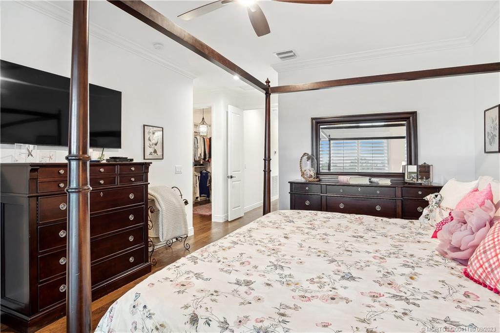 519 Southwest Ocean Boulevard Stuart, FL 34994 - Photo 15 of 27 a bedroom with a bed and a flat screen tv