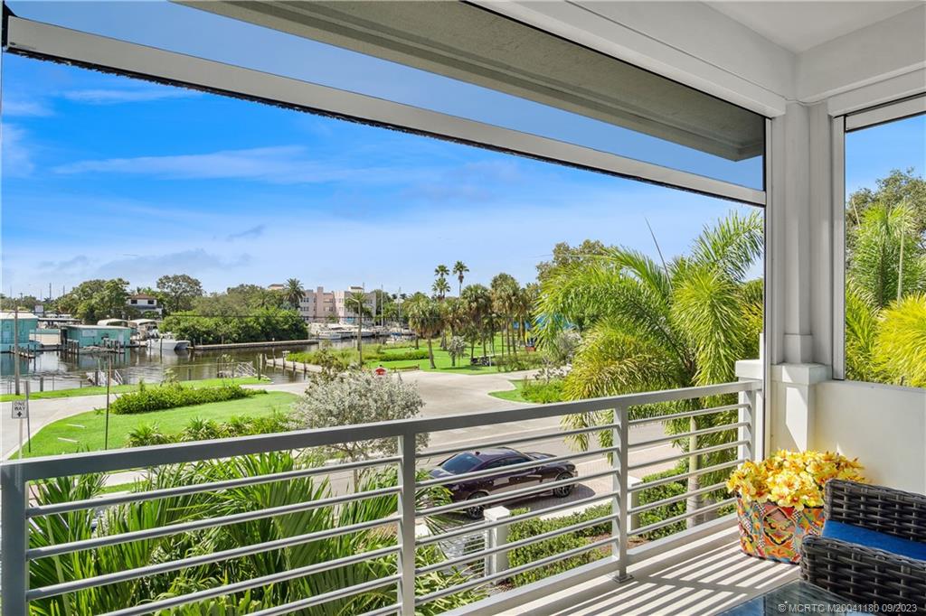 519 Southwest Ocean Boulevard Stuart, FL 34994 - Photo 19 of 27 a view of a balcony with floor to ceiling windows with wooden floor