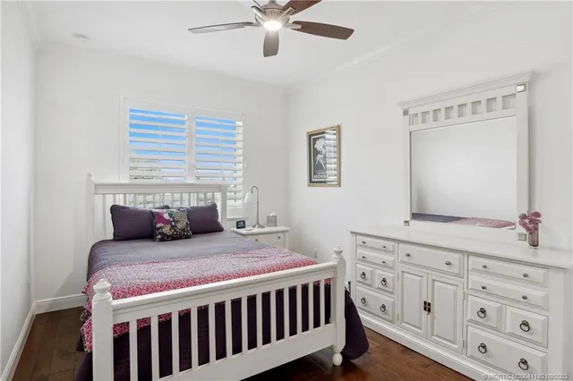 a bedroom with a bed a window and dresser