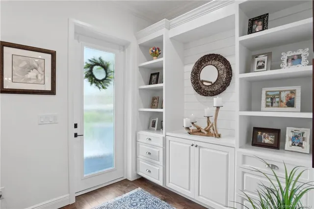 a front view of a house with entryway and wooden floor
