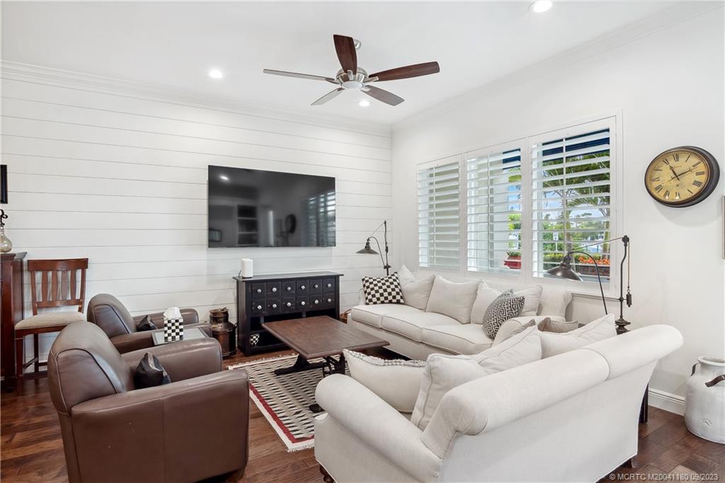 519 Southwest Ocean Boulevard Stuart, FL 34994 - Photo 7 of 27 a living room with furniture a large window and a flat screen tv