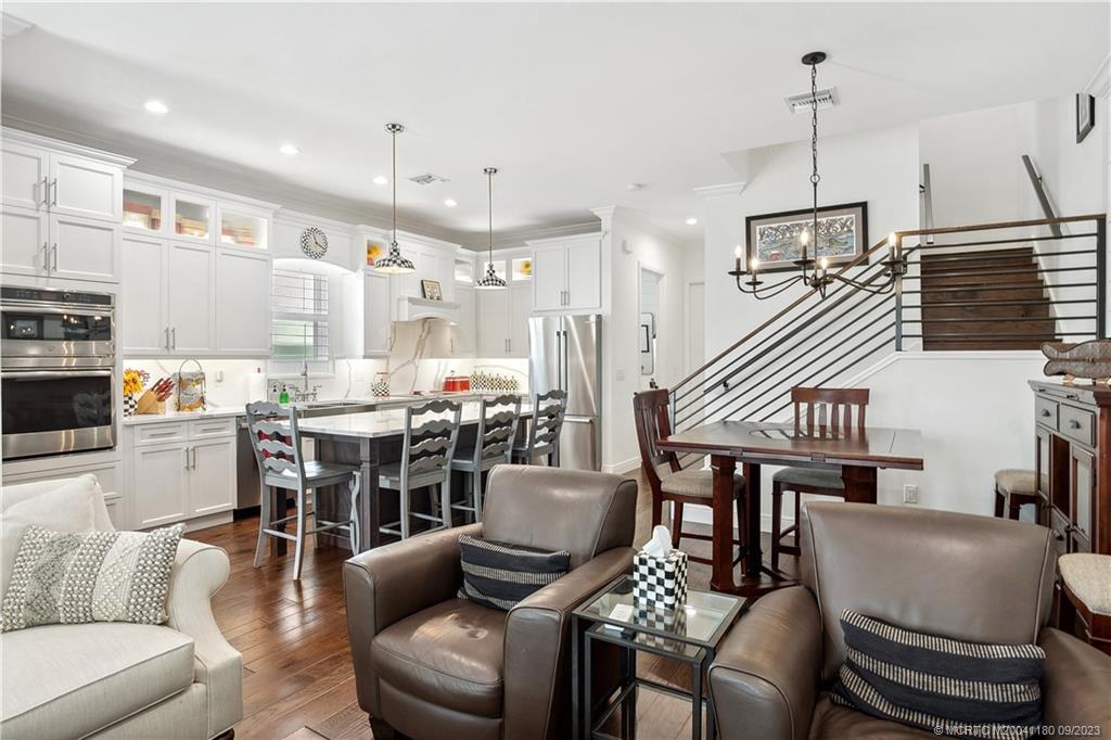 519 Southwest Ocean Boulevard Stuart, FL 34994 - Photo 8 of 27 a living room with furniture kitchen view and a chandelier