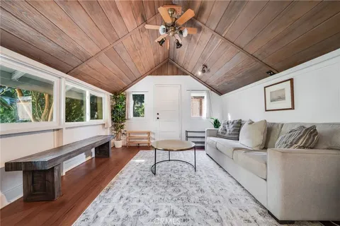 a living room with furniture ceiling fan and a rug