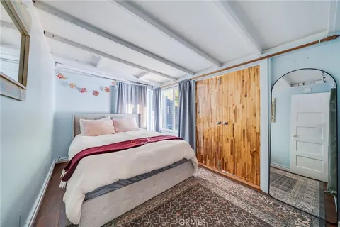 a bedroom with a bed and a mirror