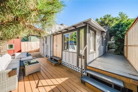 a view of balcony with wooden floor and outdoor seating
