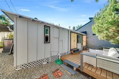 a backyard of a house with table and chairs