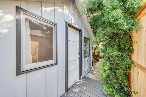 a view of an house with backyard and sitting area