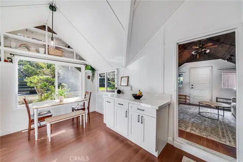 a kitchen with stainless steel appliances granite countertop a stove and a wooden floors
