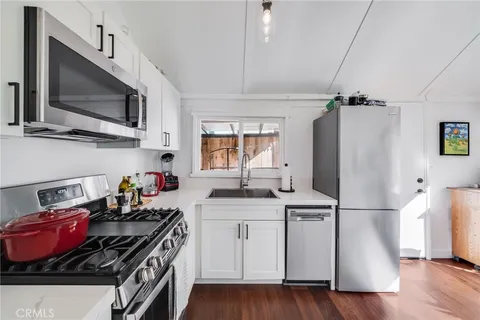 a kitchen with stainless steel appliances a sink stove and refrigerator