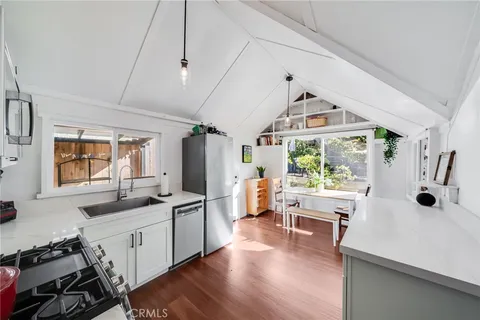 a kitchen with a sink appliances and a counter top space