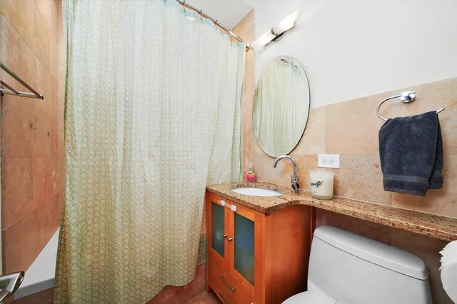a bathroom with a sink vanity and a mirror