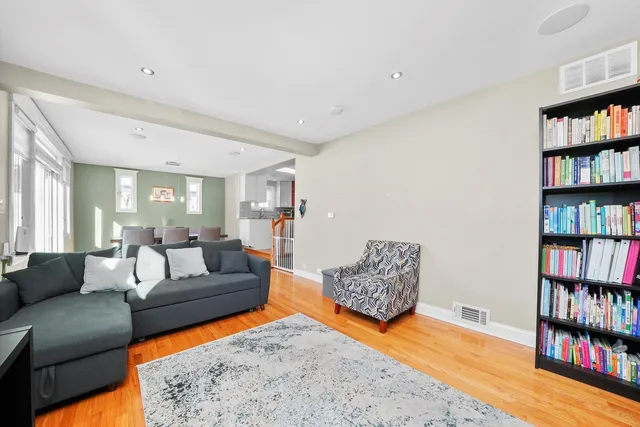 a living room with furniture and a book shelf