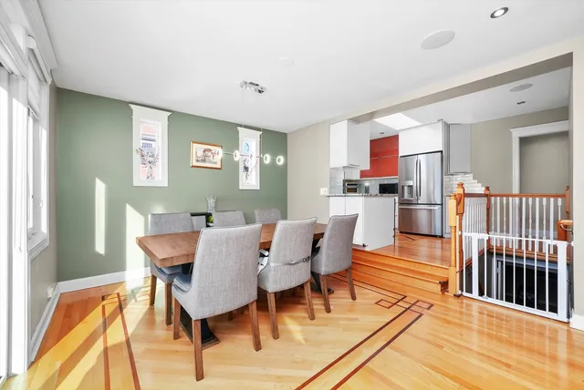 a dining room with furniture and wooden floor