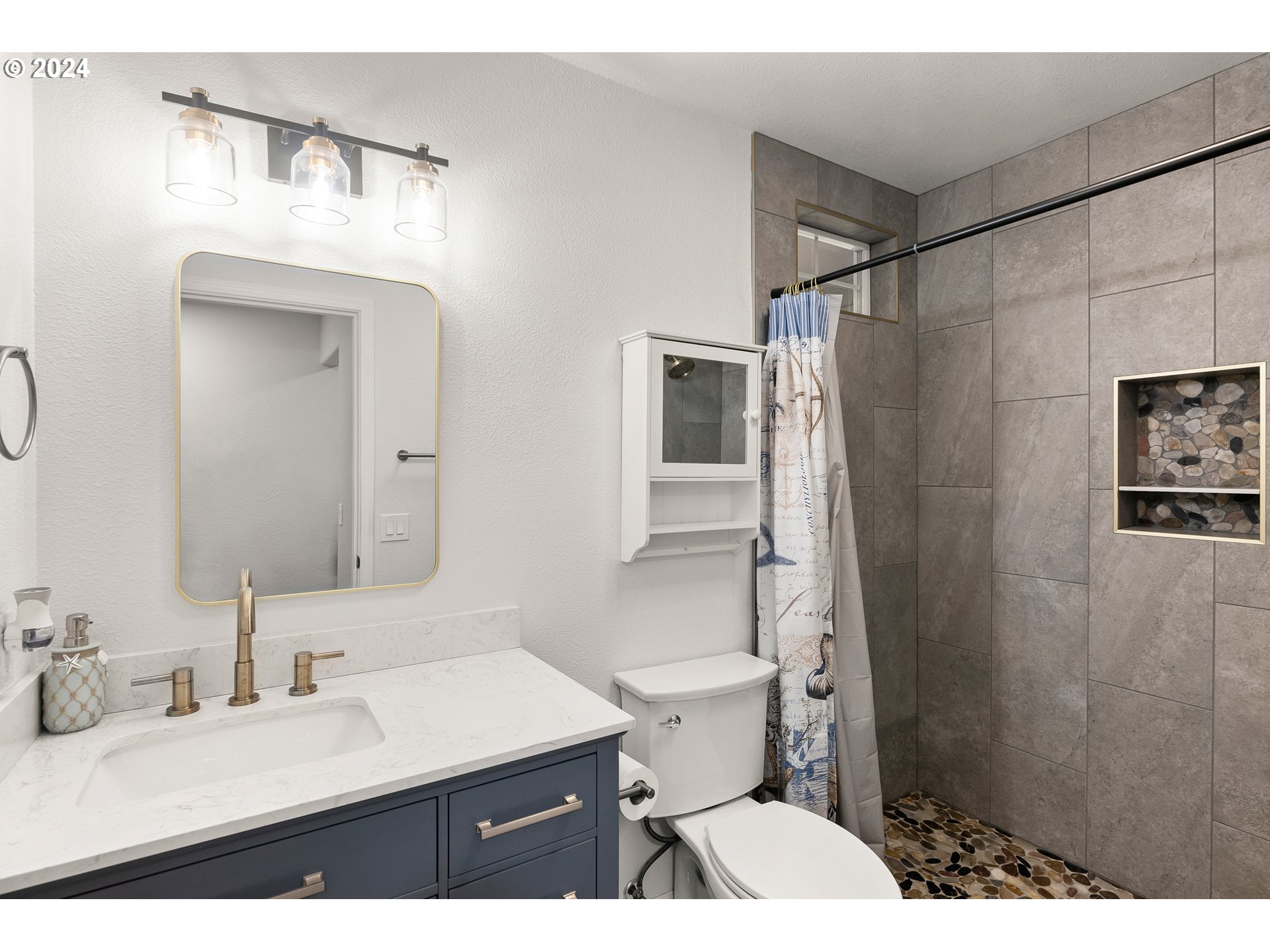 216 Southwest Sutherland Way Beaverton, OR 97006 - Photo 13 of 19 a bathroom with a sink toilet a mirror and shower